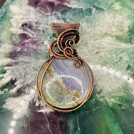 Circular Indonesian Moss Agate stone wrapped in antiqued copper