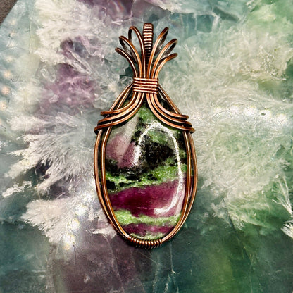 Oval Ruby Zoisite stone wrapped in copper