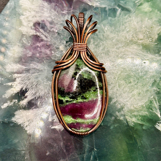 Oval Ruby Zoisite stone wrapped in copper