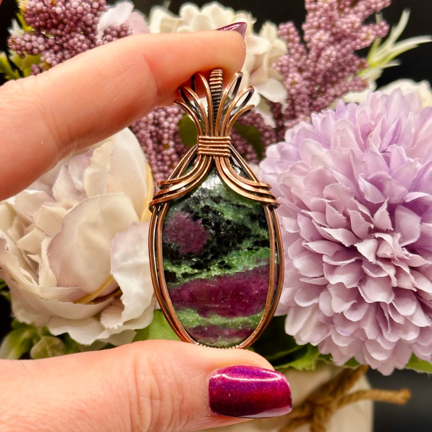 Oval Ruby Zoisite stone wrapped in copper