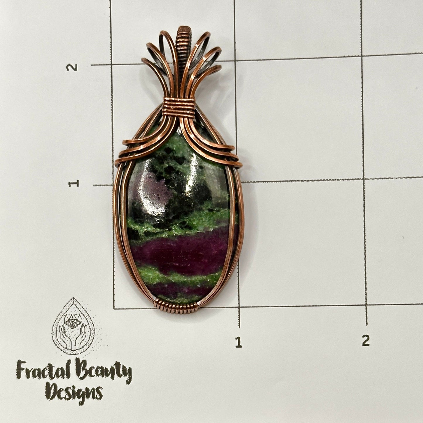 Oval Ruby Zoisite stone wrapped in copper