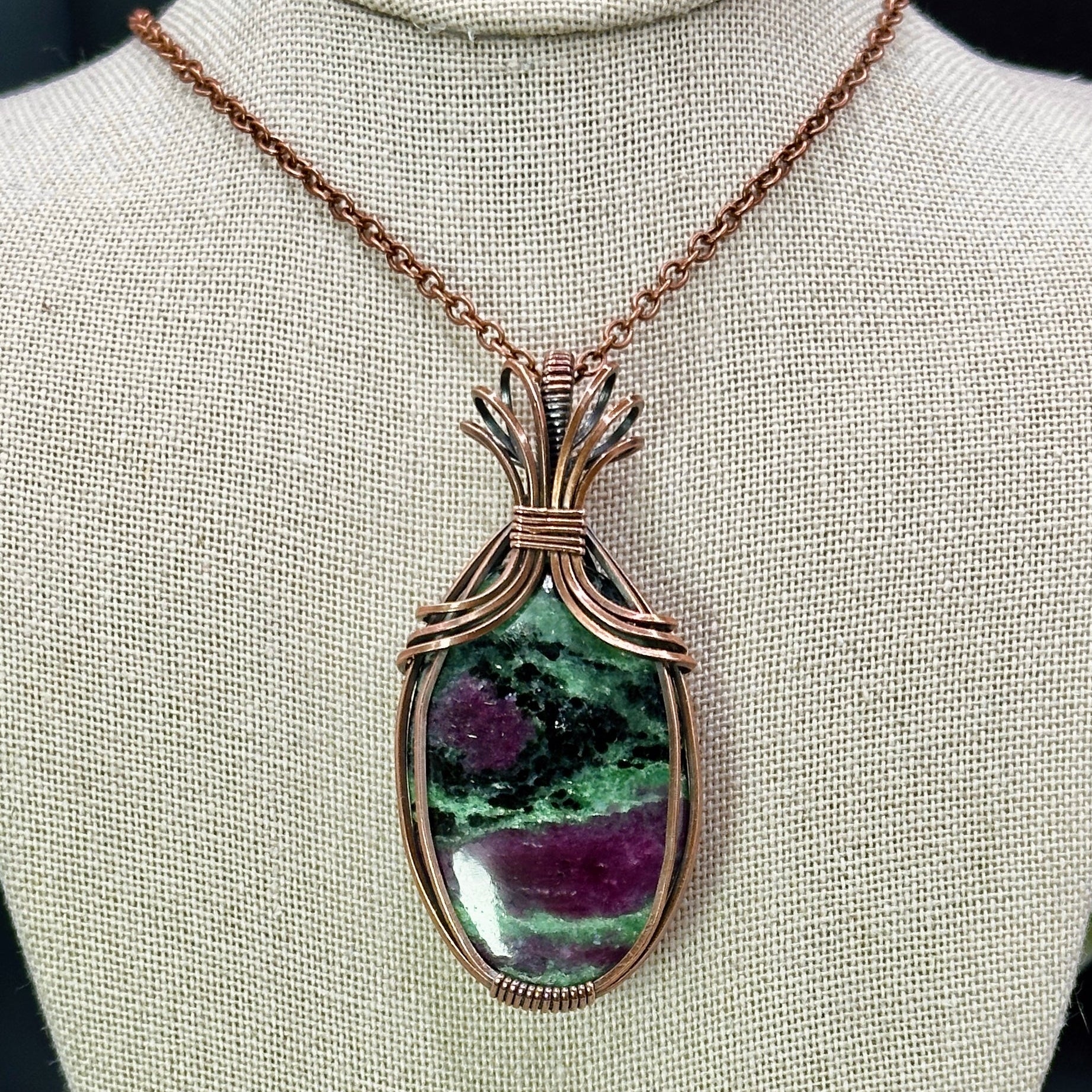 Oval Ruby Zoisite stone wrapped in copper
