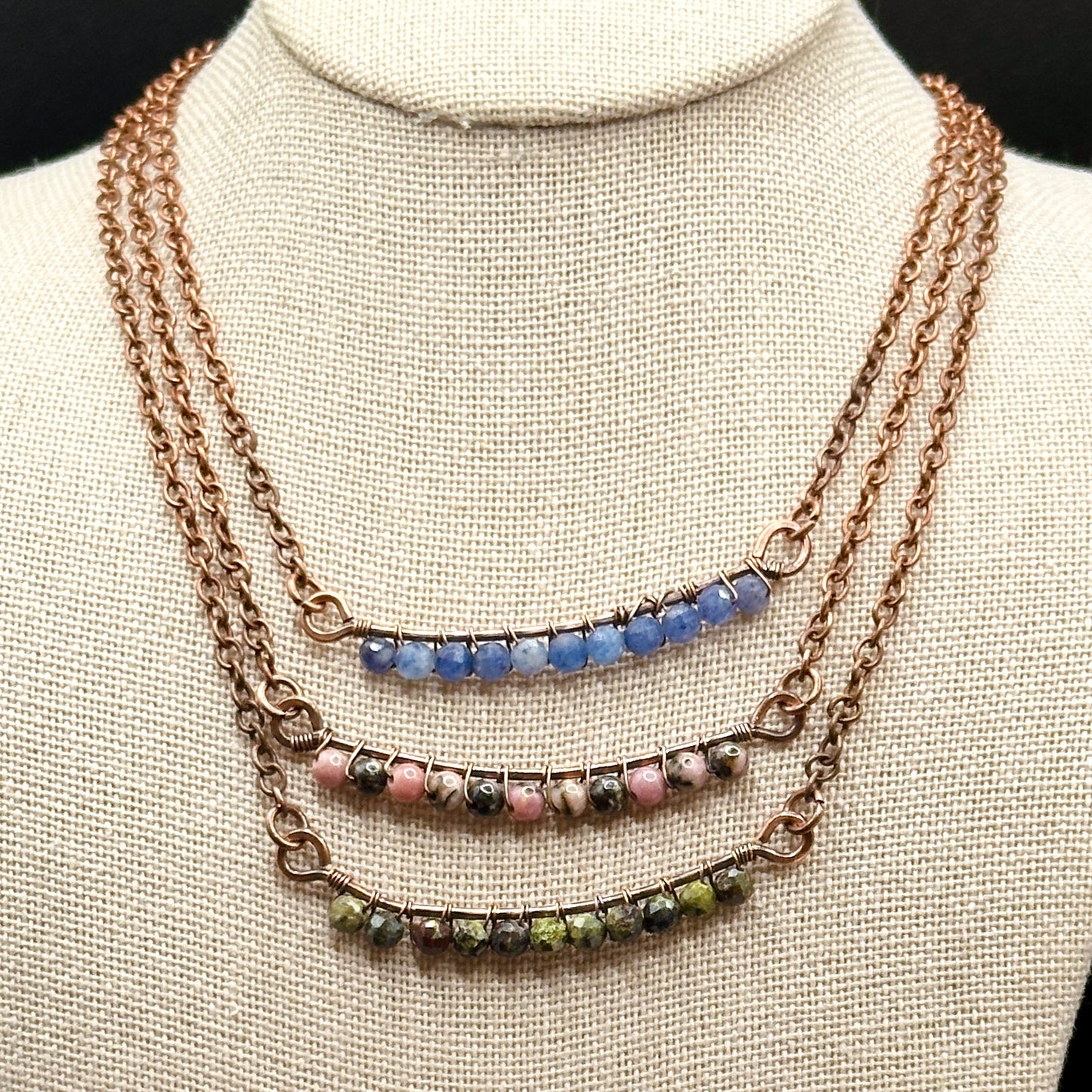 Bar necklace options of rhodonite, dragons blood, and blue aventurine