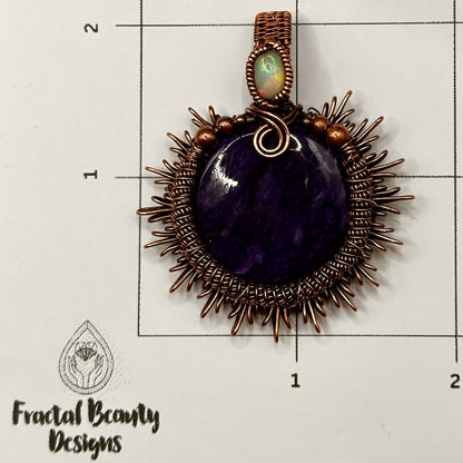 Charoite stone wrapped in sunburst design in antiqued copper accented with a double coil and ethiopian opal on measuring grid