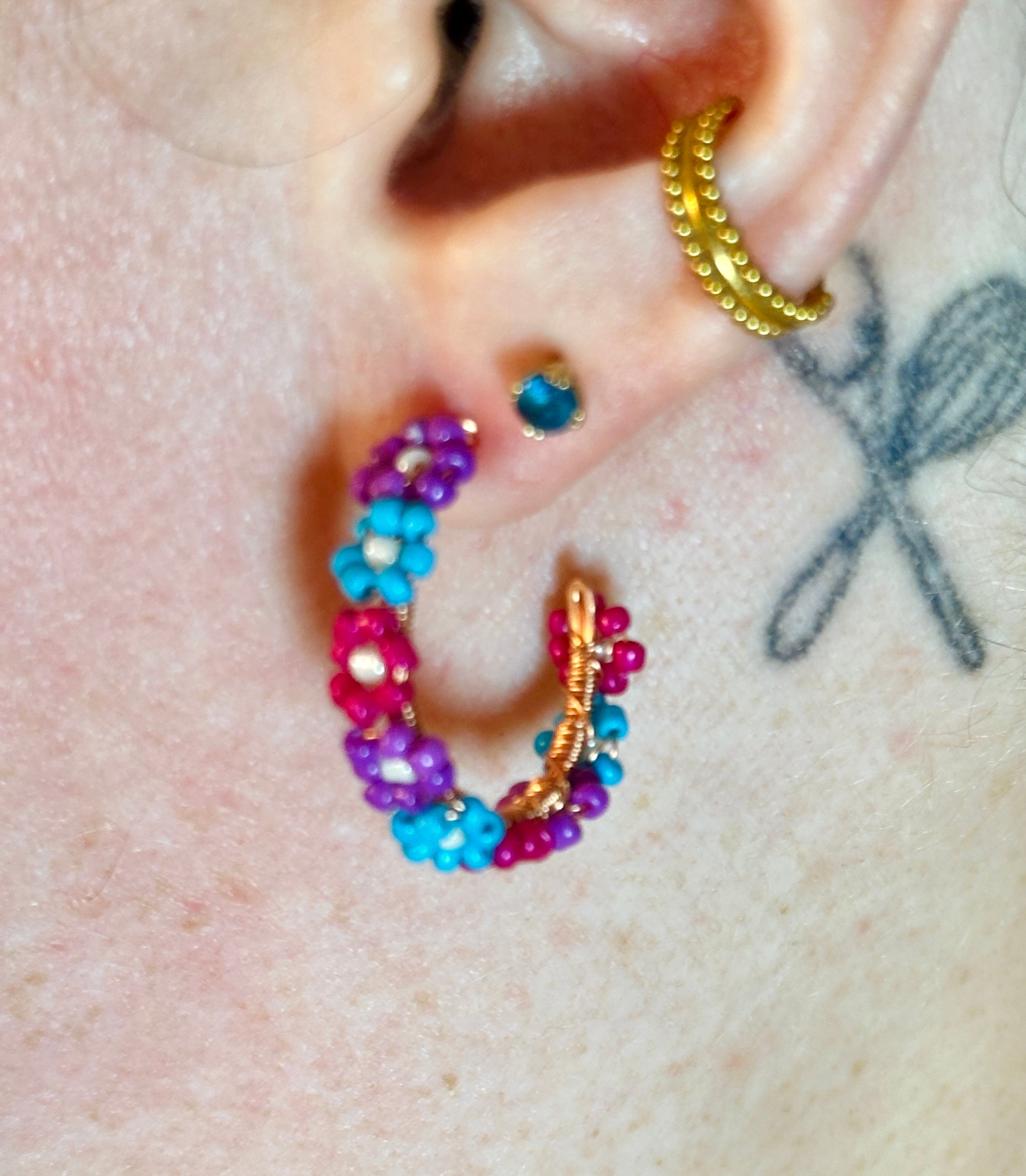 photo showing the flower bead hoop earrings being worn from the side