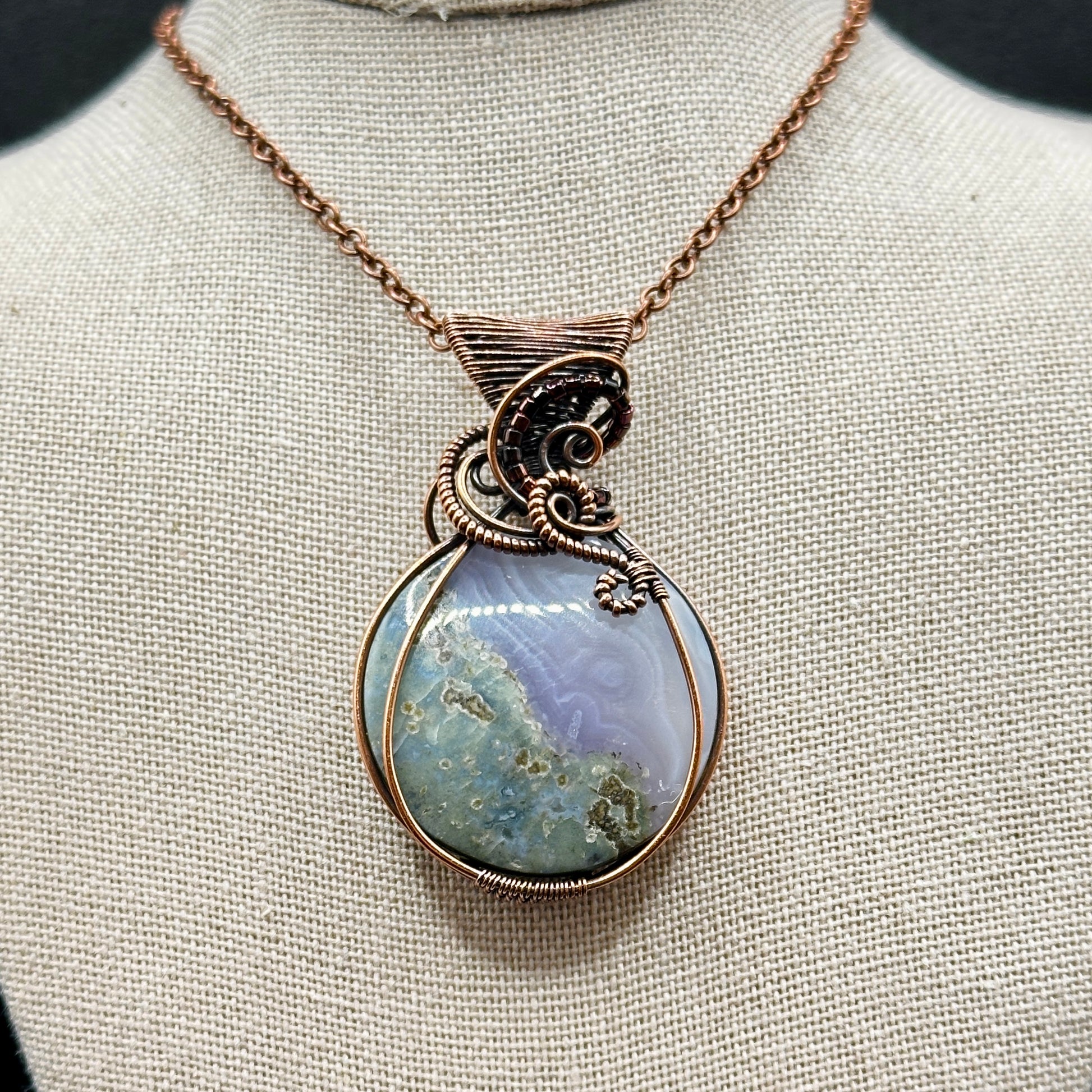 Circular Indonesian Moss Agate stone wrapped in antiqued copper