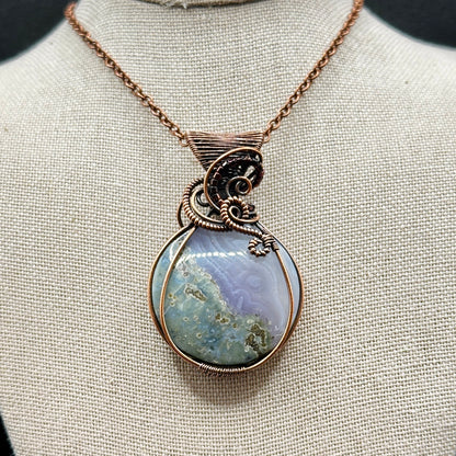 Circular Indonesian Moss Agate stone wrapped in antiqued copper