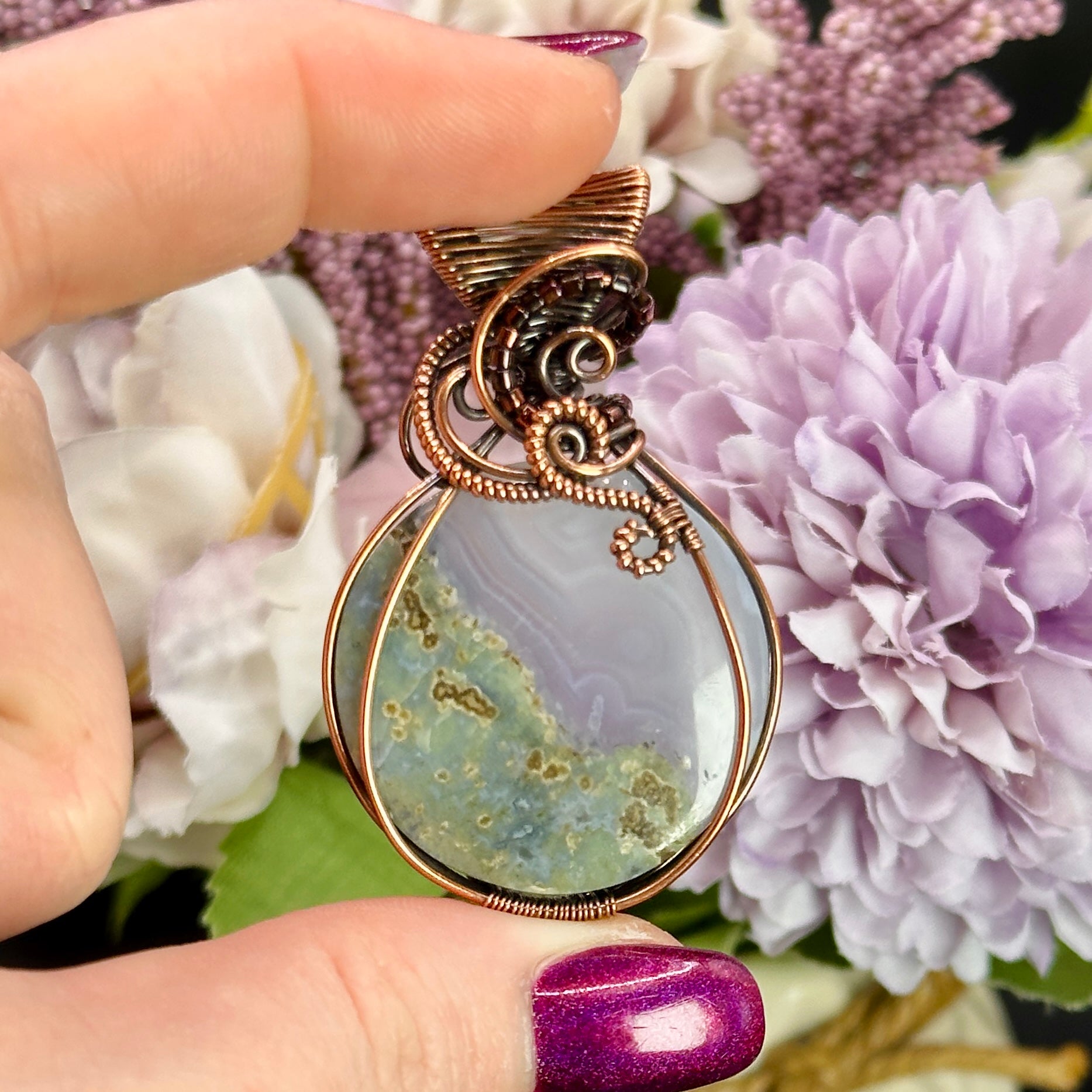 Circular Indonesian Moss Agate stone wrapped in antiqued copper