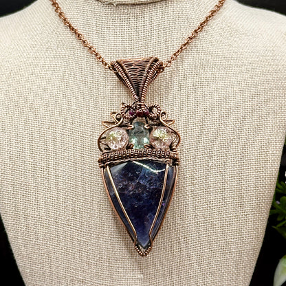 An Iolite Sunstone wrapped in antiuqed copper with 2 Uranium Glass Beads & Fluorite Facet