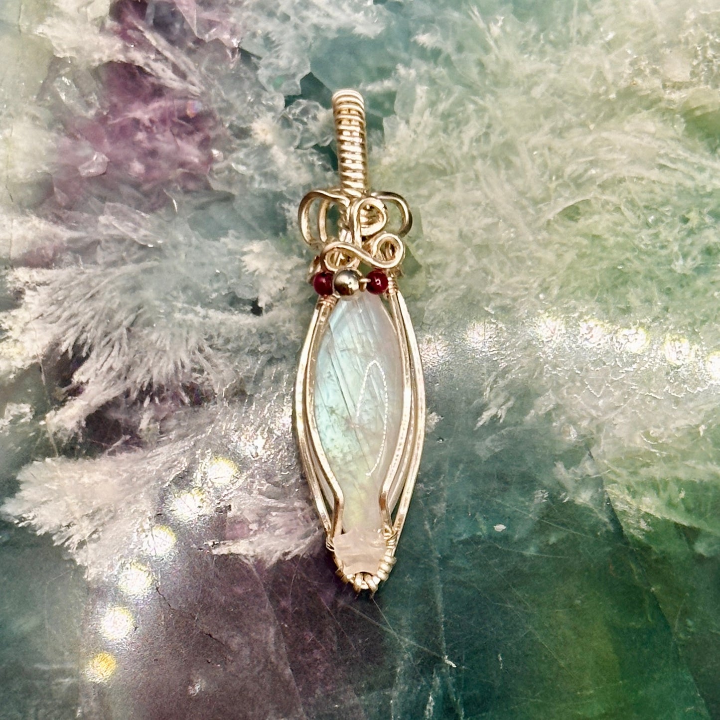 Marquis moonstone with garnet and silver beads and a rose quartz star, wrapped in silver plated copper wire