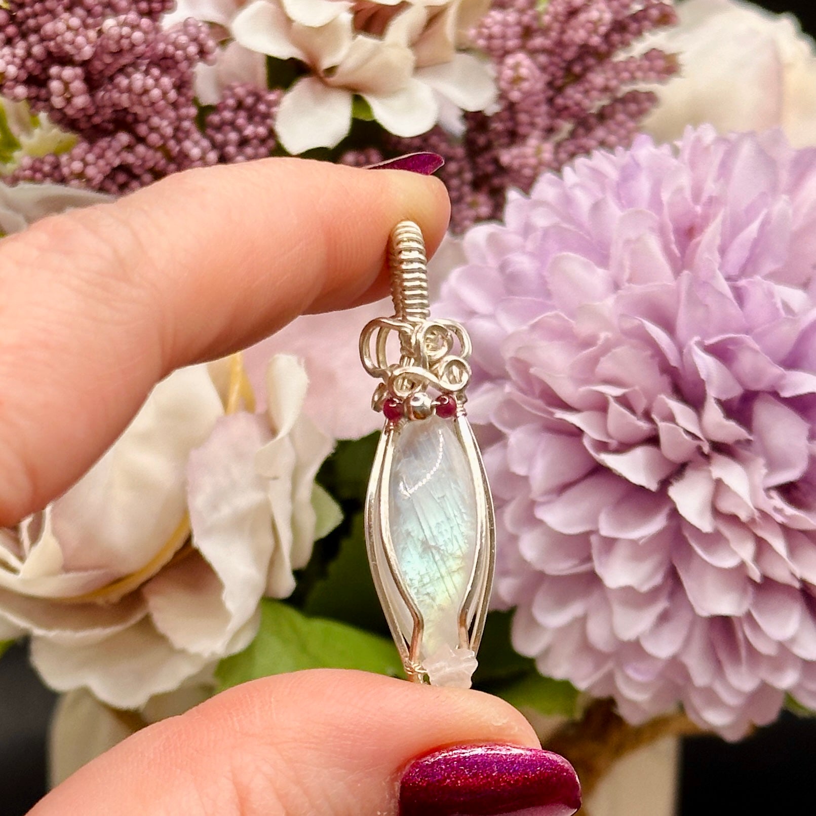 Marquis moonstone with garnet and silver beads and a rose quartz star, wrapped in silver plated copper wire