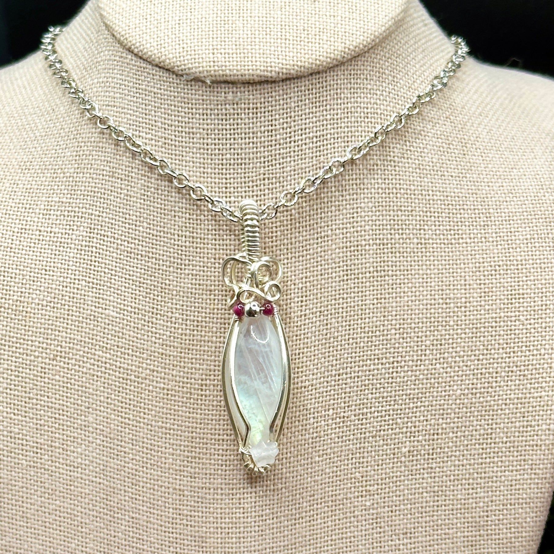 Marquis moonstone with garnet and silver beads and a rose quartz star, wrapped in silver plated copper wire