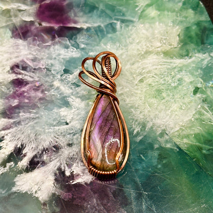 pear shaped purple and orange labradorite stone wrapped in copper