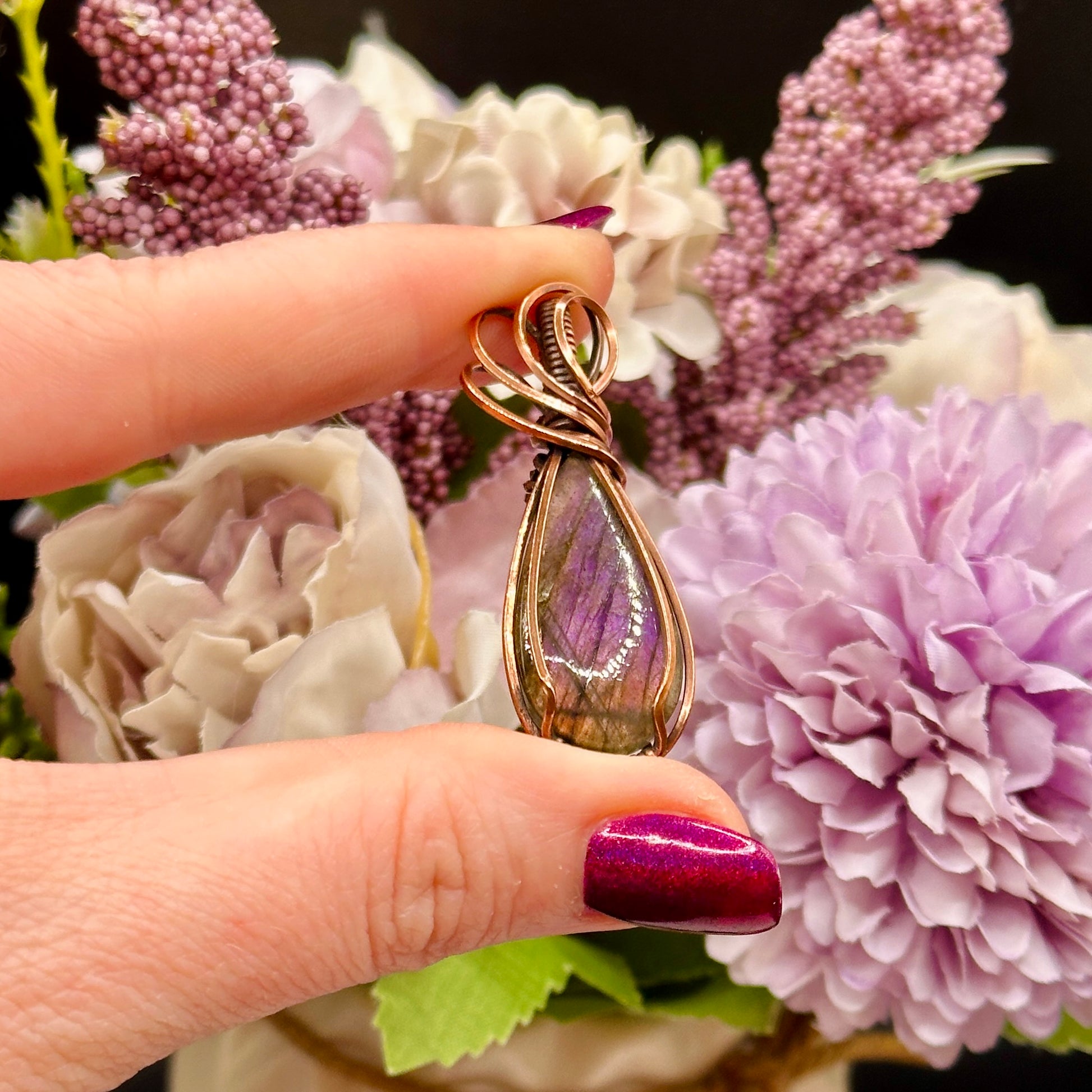 pear shaped purple and orange labradorite stone wrapped in copper