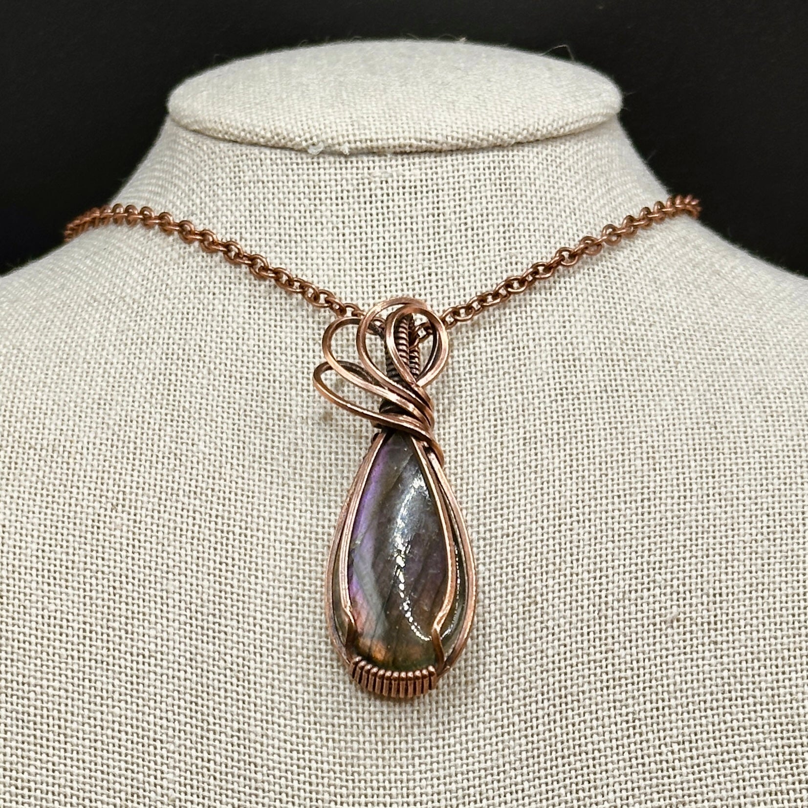 pear shaped purple and orange labradorite stone wrapped in copper