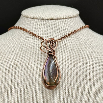 pear shaped purple and orange labradorite stone wrapped in copper