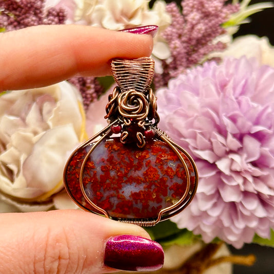 red plume moss agate stone wrapped in antiqued copper with rose and garnet accents 
