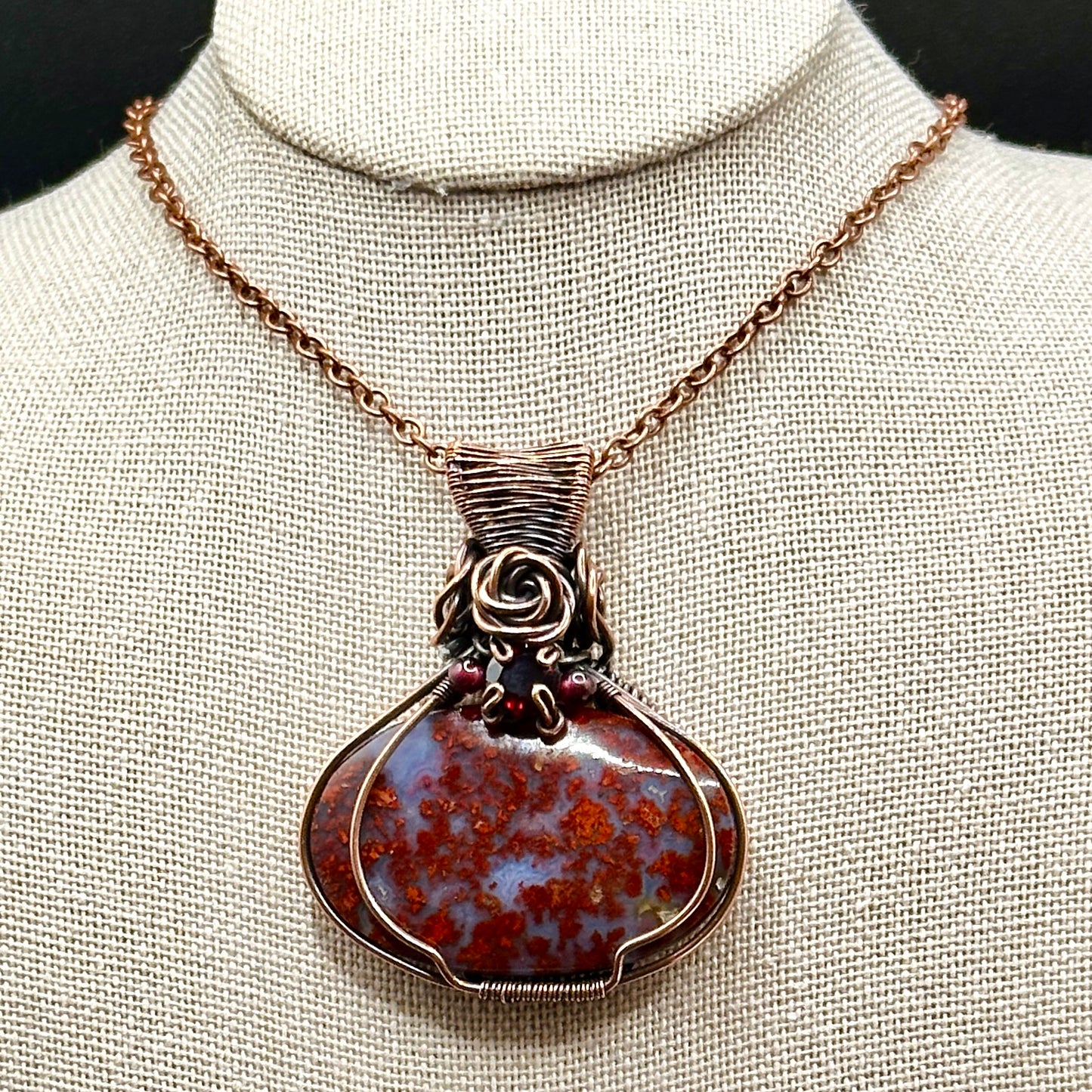 red plume moss agate stone wrapped in antiqued copper with rose and garnet accents 