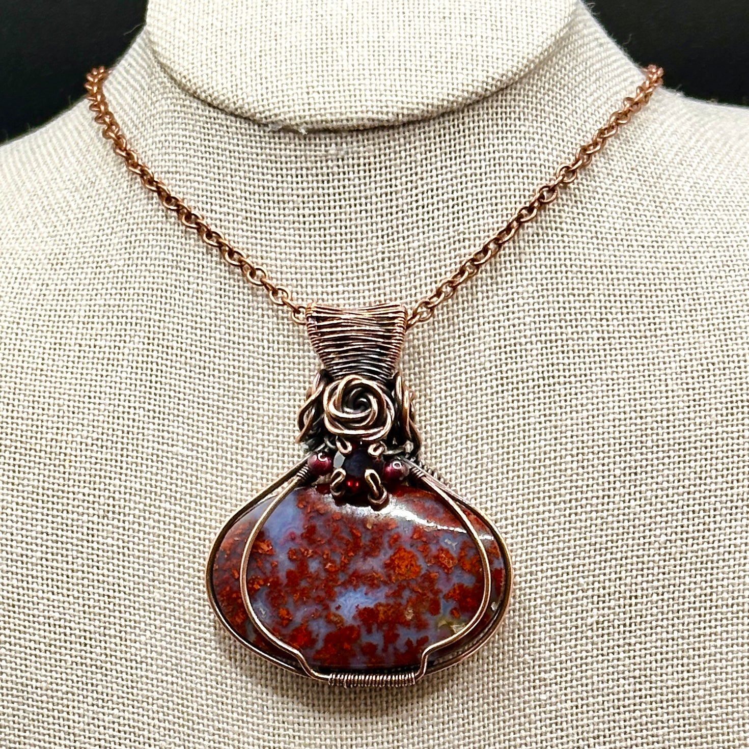 red plume moss agate stone wrapped in antiqued copper with rose and garnet accents 