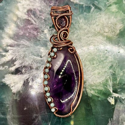 Trapiche Amethyst wrapped in antiqued copper w/ Amazonite beads & an Iolite Sunstone facet