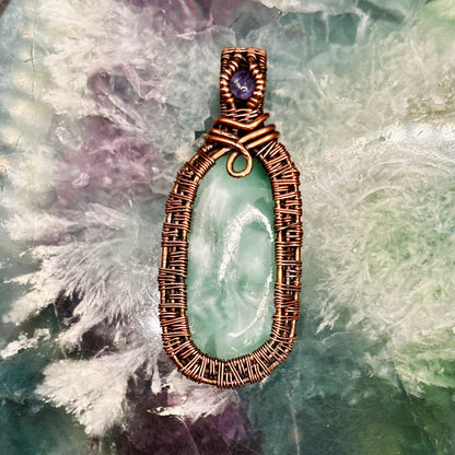 victoria stone with intricately woven antiqued copper frame accented with tanzanite facet