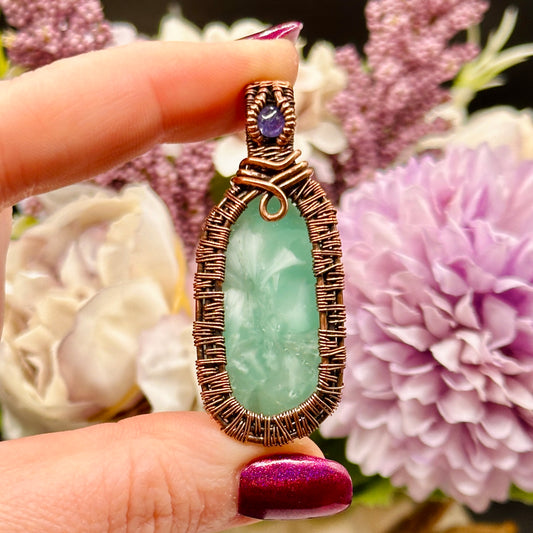 victoria stone with intricately woven antiqued copper frame accented with tanzanite facet