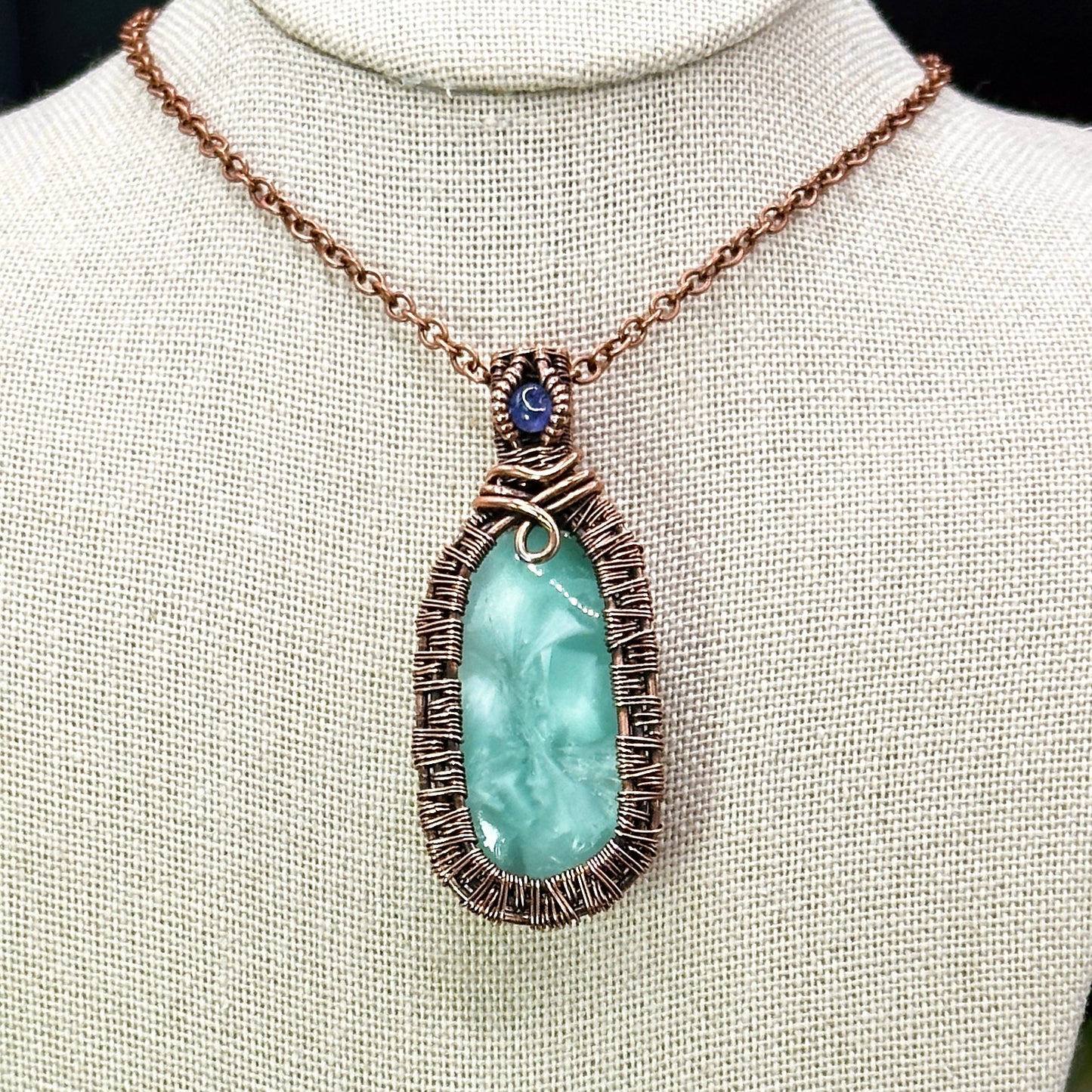 victoria stone with intricately woven antiqued copper frame accented with tanzanite facet