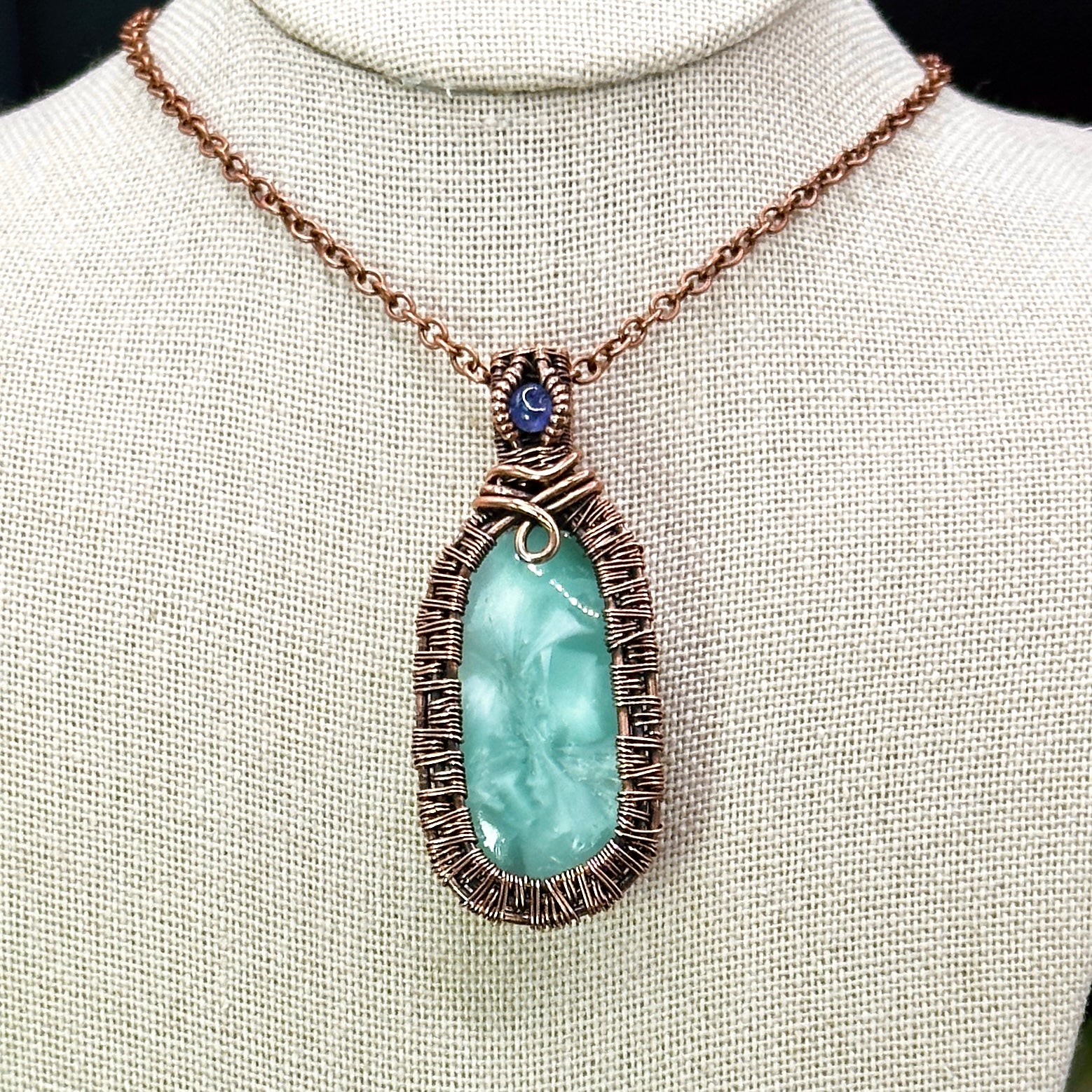 victoria stone with intricately woven antiqued copper frame accented with tanzanite facet