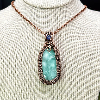 victoria stone with intricately woven antiqued copper frame accented with tanzanite facet