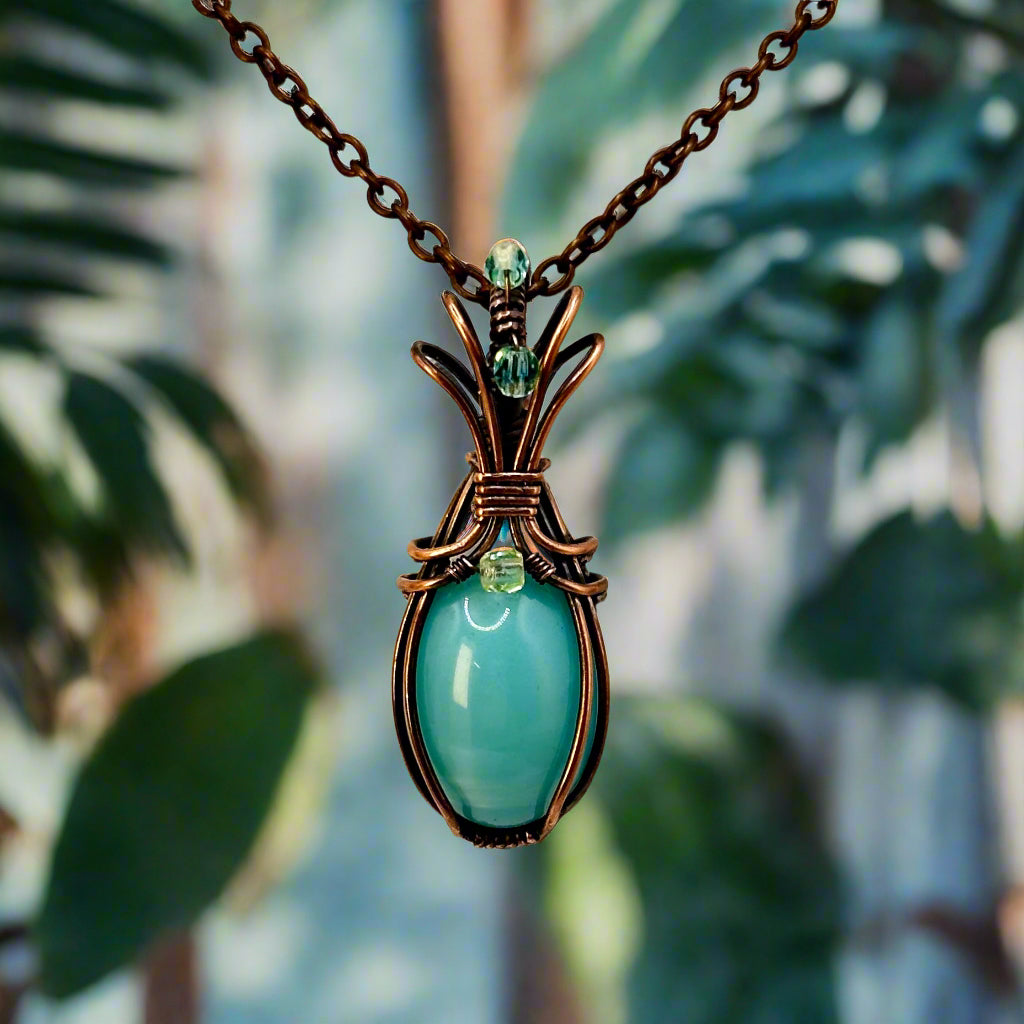 Necklace with a vintage blue uranium glass pendant with uranium glass beads, wrapped in copper