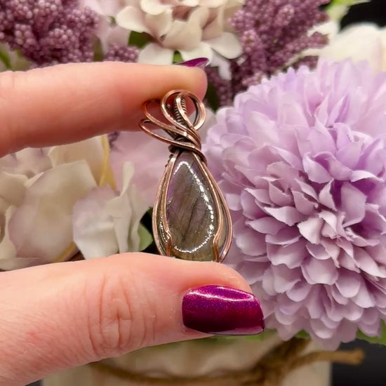 pear shaped purple and orange labradorite stone wrapped in copper, video to show the flash of the stone