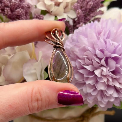 pear shaped purple and orange labradorite stone wrapped in copper, video to show the flash of the stone