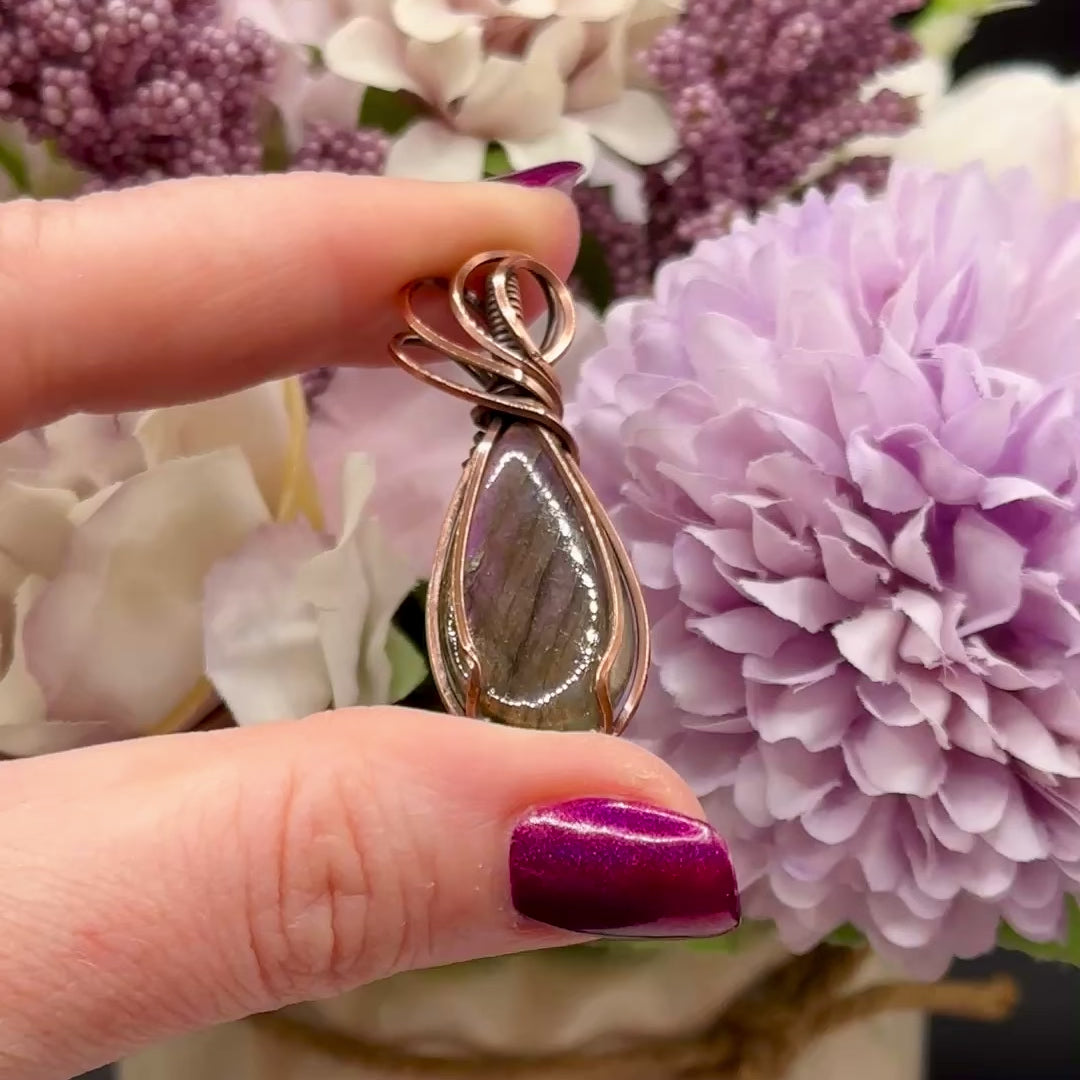 pear shaped purple and orange labradorite stone wrapped in copper, video to show the flash of the stone